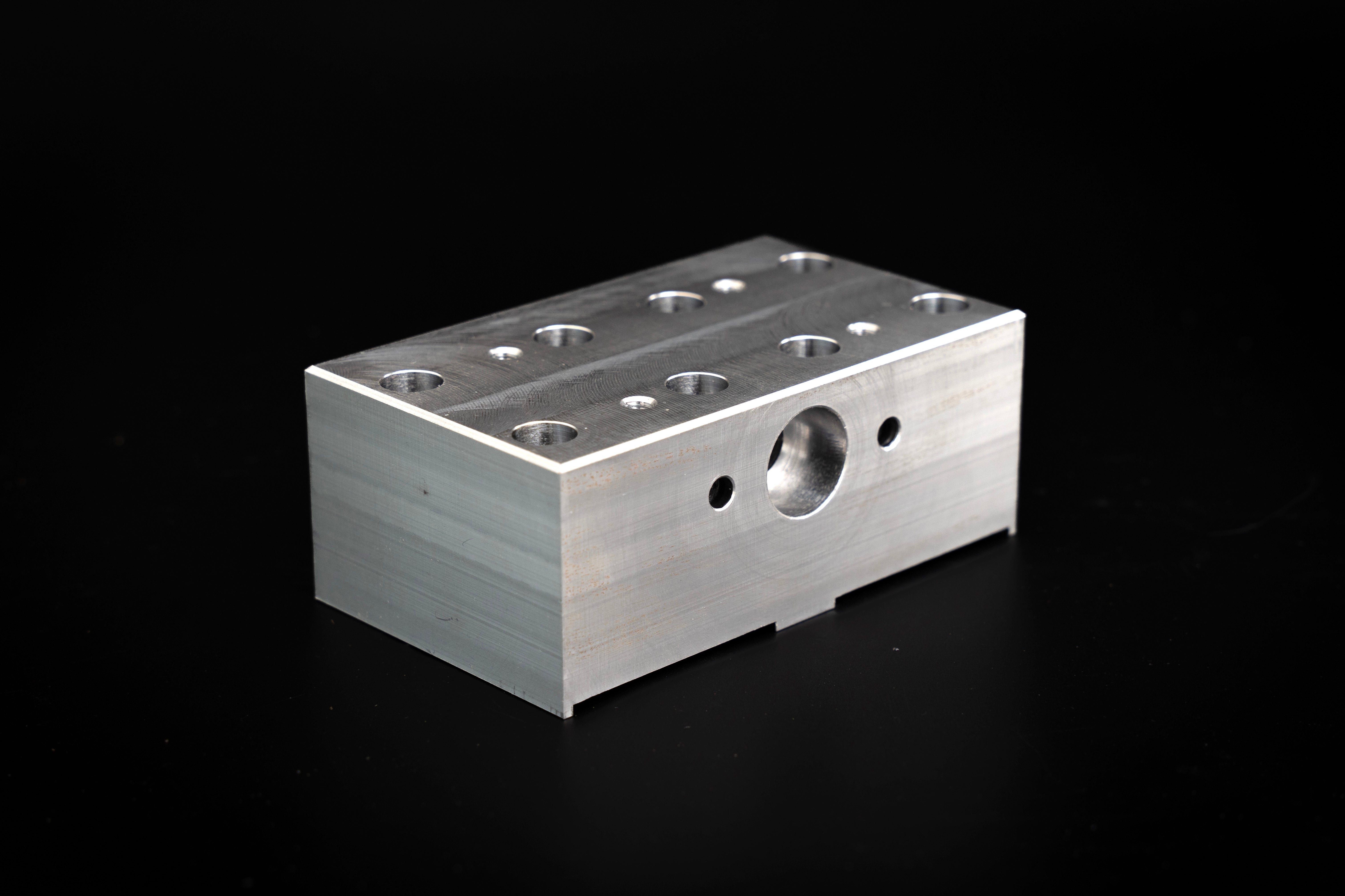 CNC-machined aluminum component with multiple bores and precision-machined surfaces