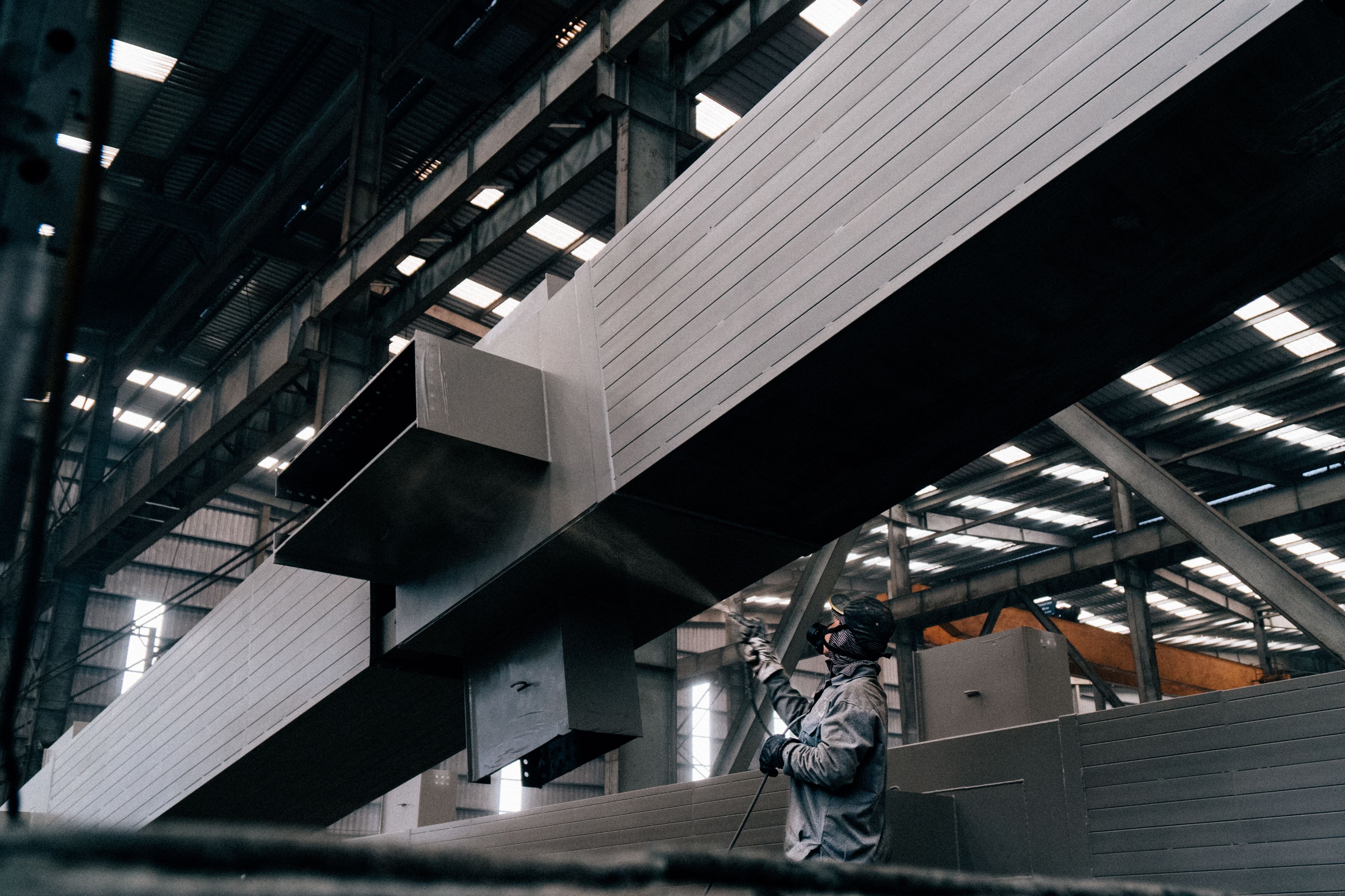 Architectural metal coating being applied to a large fabricated beam