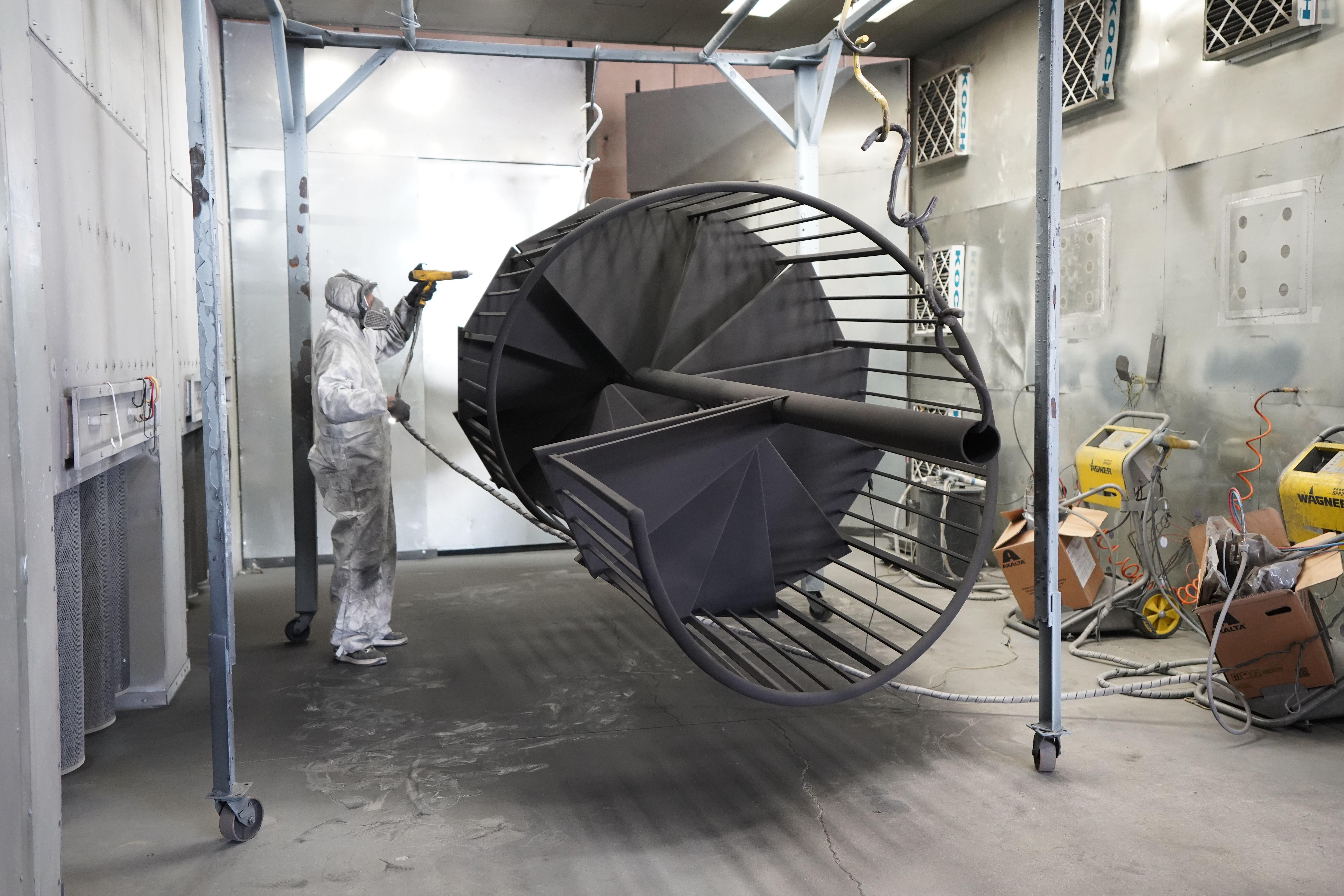 Architectural powder coating being applied to a metal staircase