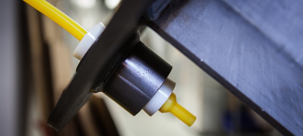 Yellow masking plug installed on an industrial part