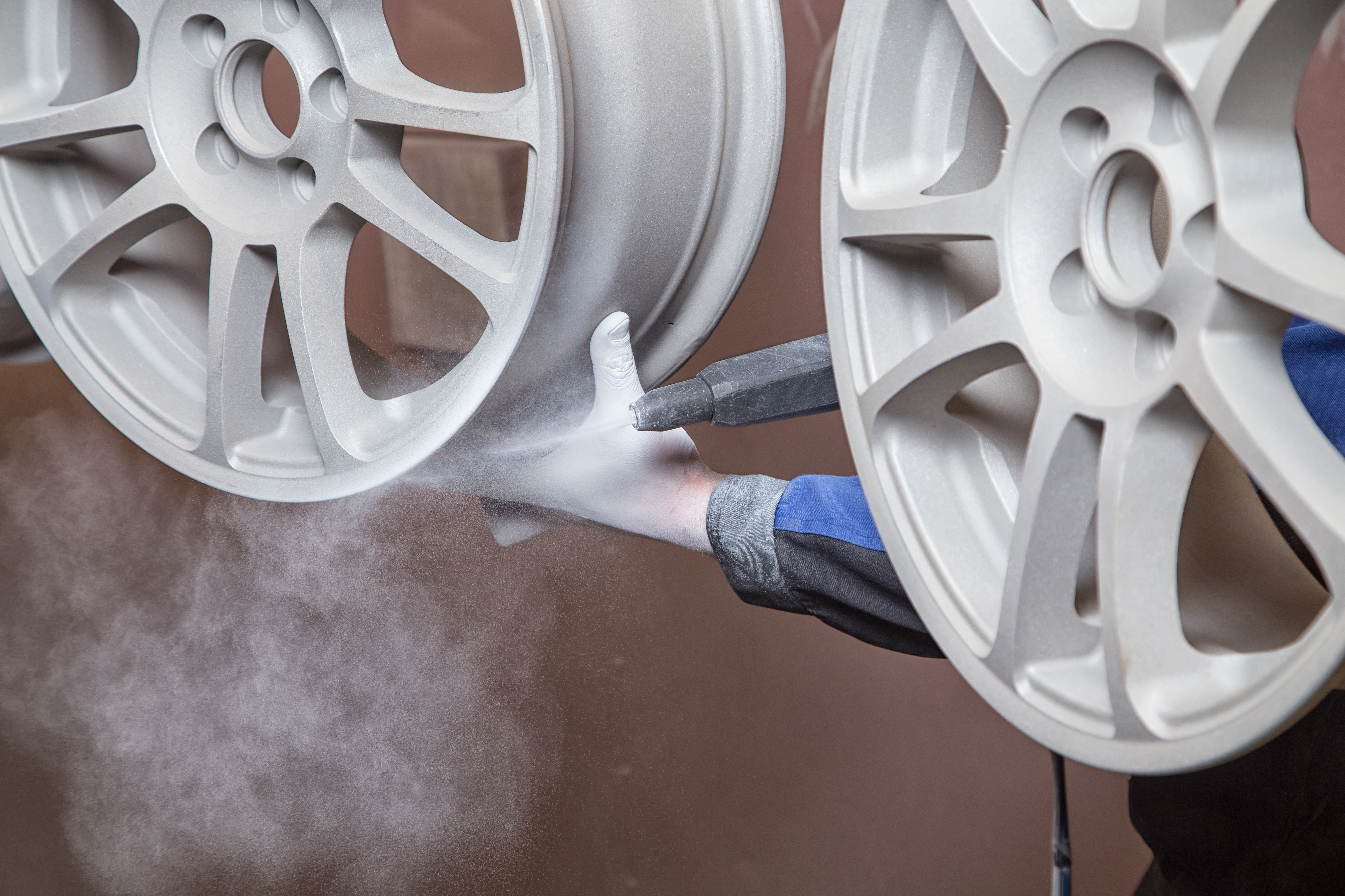 Close-up of white automotive wheels during the industrial finishing process